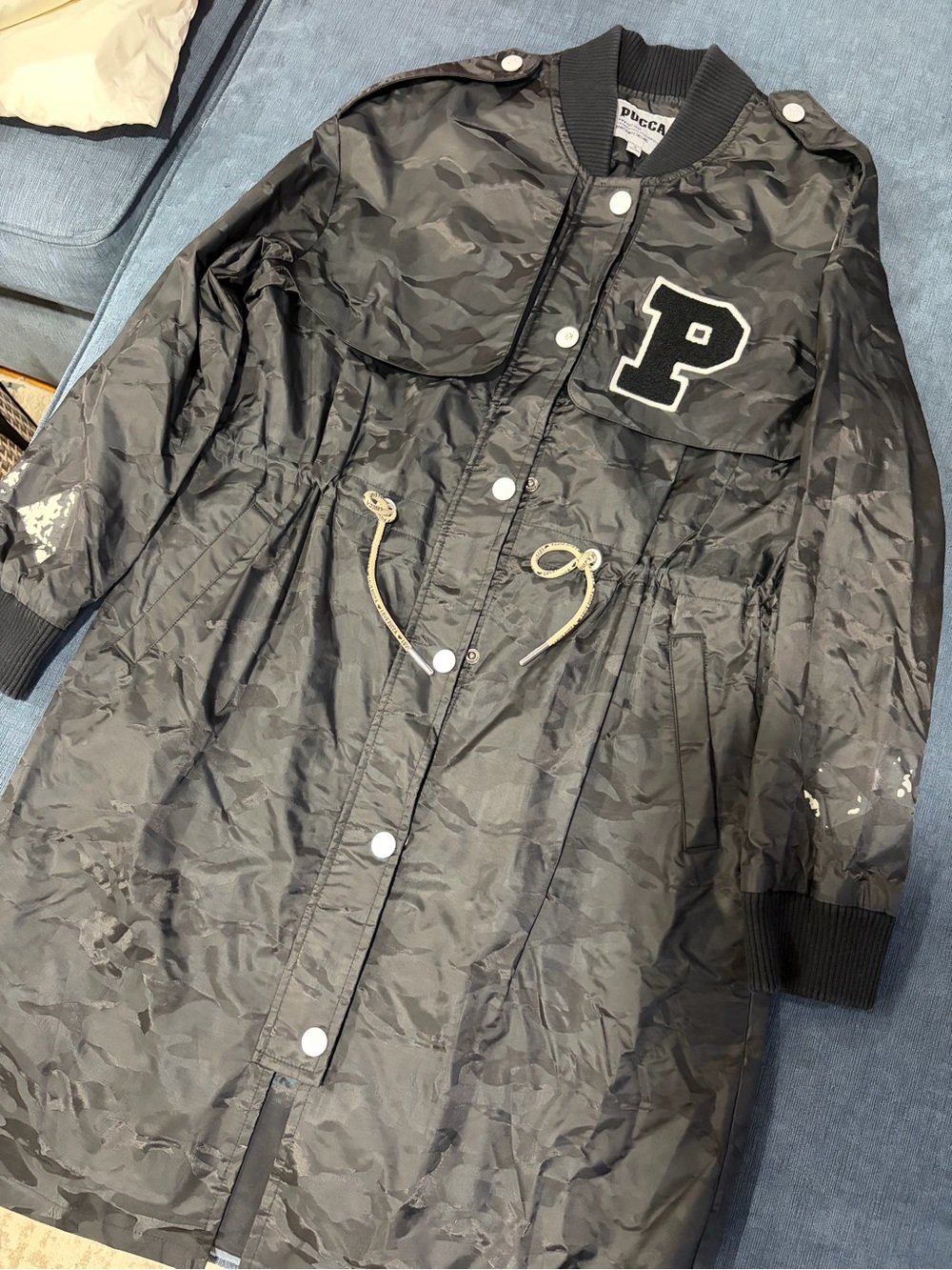 Black Puffer-Style Coat with 'P' Patch